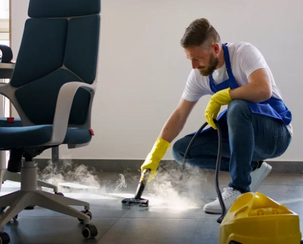 Professional cleaning service person using steam cleaner office